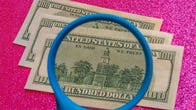 cash under a magnifying glass