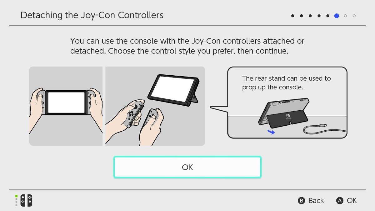 Switch OLED "Detaching the Joy-Con Controllers" screen: You can use the console with the Joy-Con controllers attached or detached. Choose the control style you prefer, then continue." with three images of possible joy-con usage: while attached to the prim
