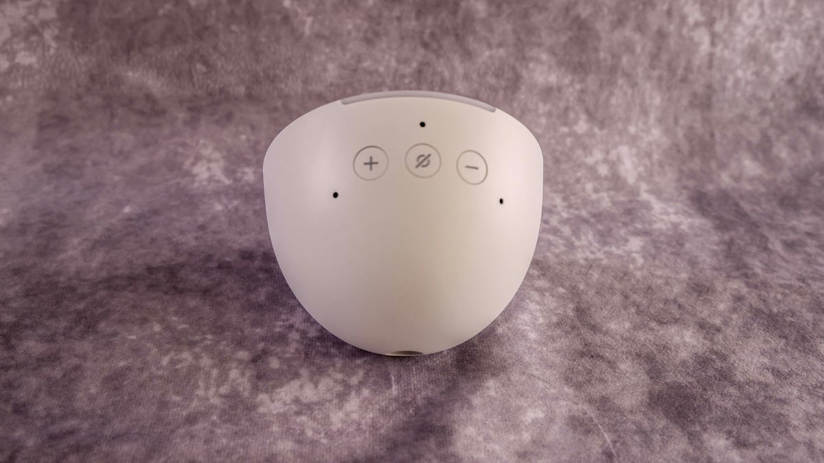 Amazon Pop smart speaker on a gray marble background