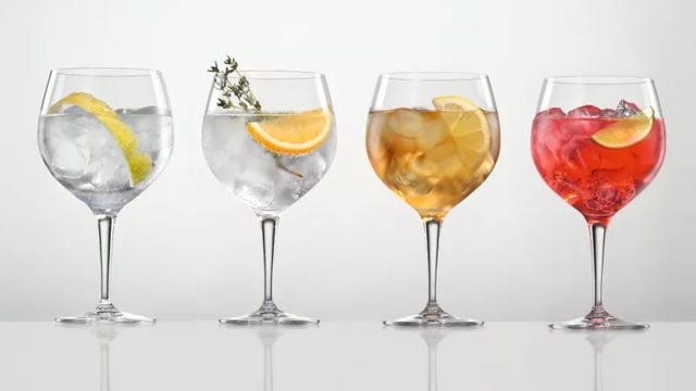 four spritz cocktails in wine glasses