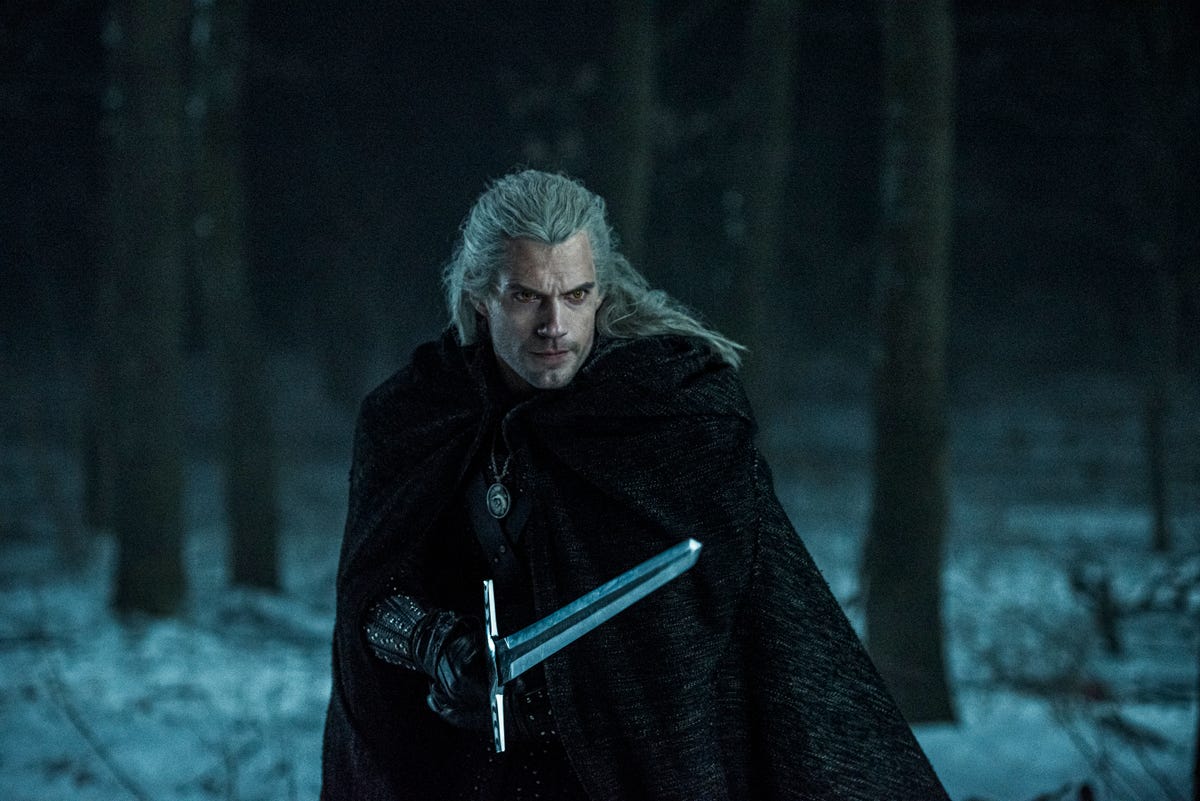 Henry Cavill holding a sword in The Witcher