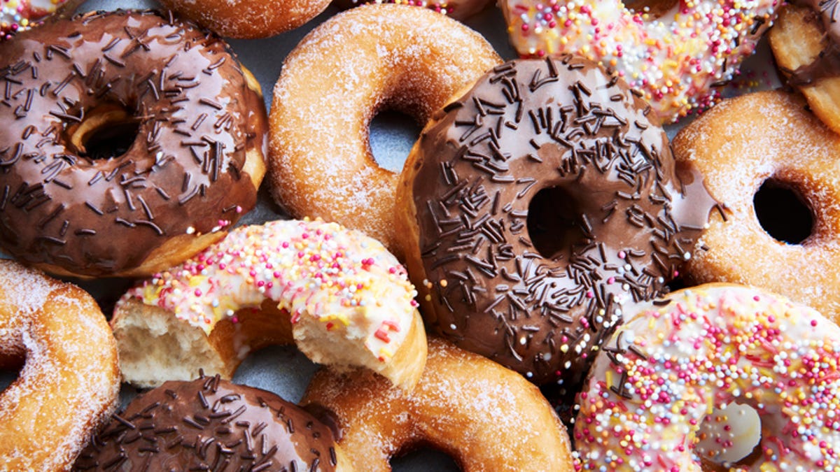 several chocolate and sprinkle donuts