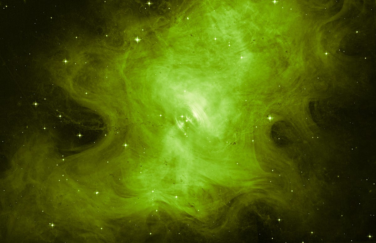 The Crab Nebula looks like a green wispy ghost fluffy itself up in space.