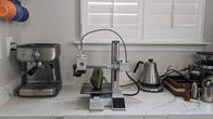 A small gray 3d printer with an external machine for adding color