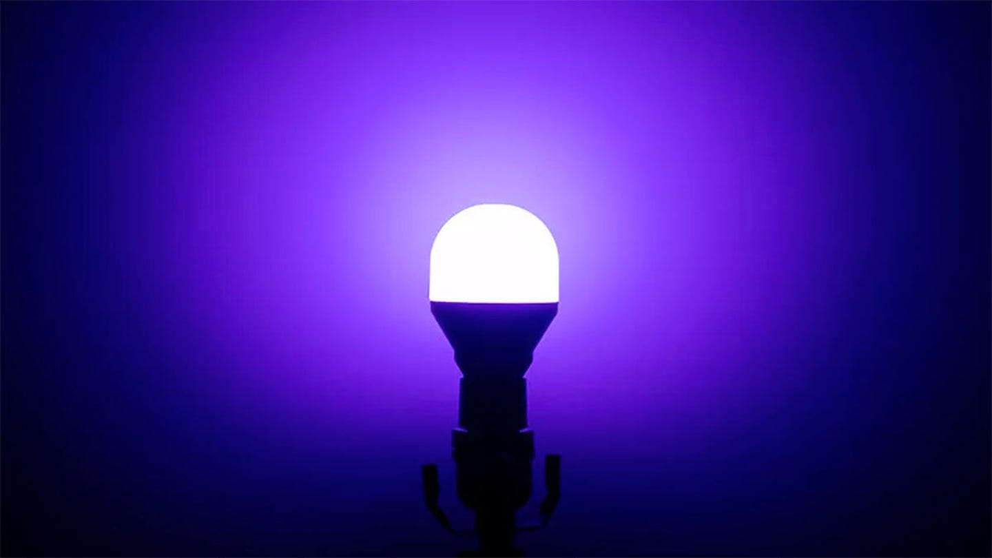 Lifx Mini Wi-Fi smart bulb against a purplish background