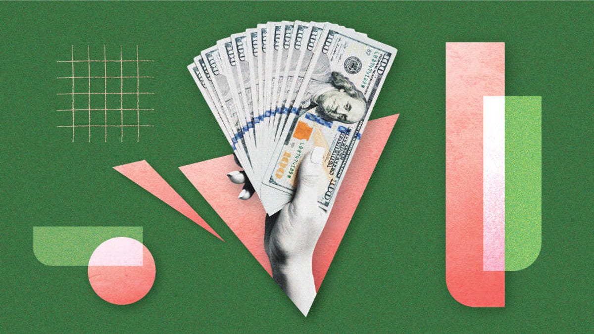 A hand holding one hundred dollar bills against a green and pink background