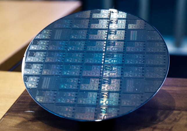 A 200mm silicon wafer​ houses IBM quantum-computing chips with 5 qubits apiece.