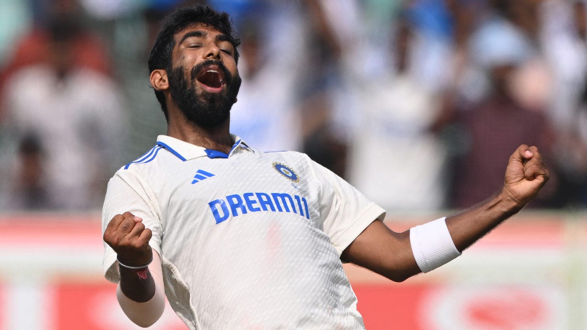 India bowler Jasprit Bumrah leaning back, celebrating with both hands clinched and his eyes closed.