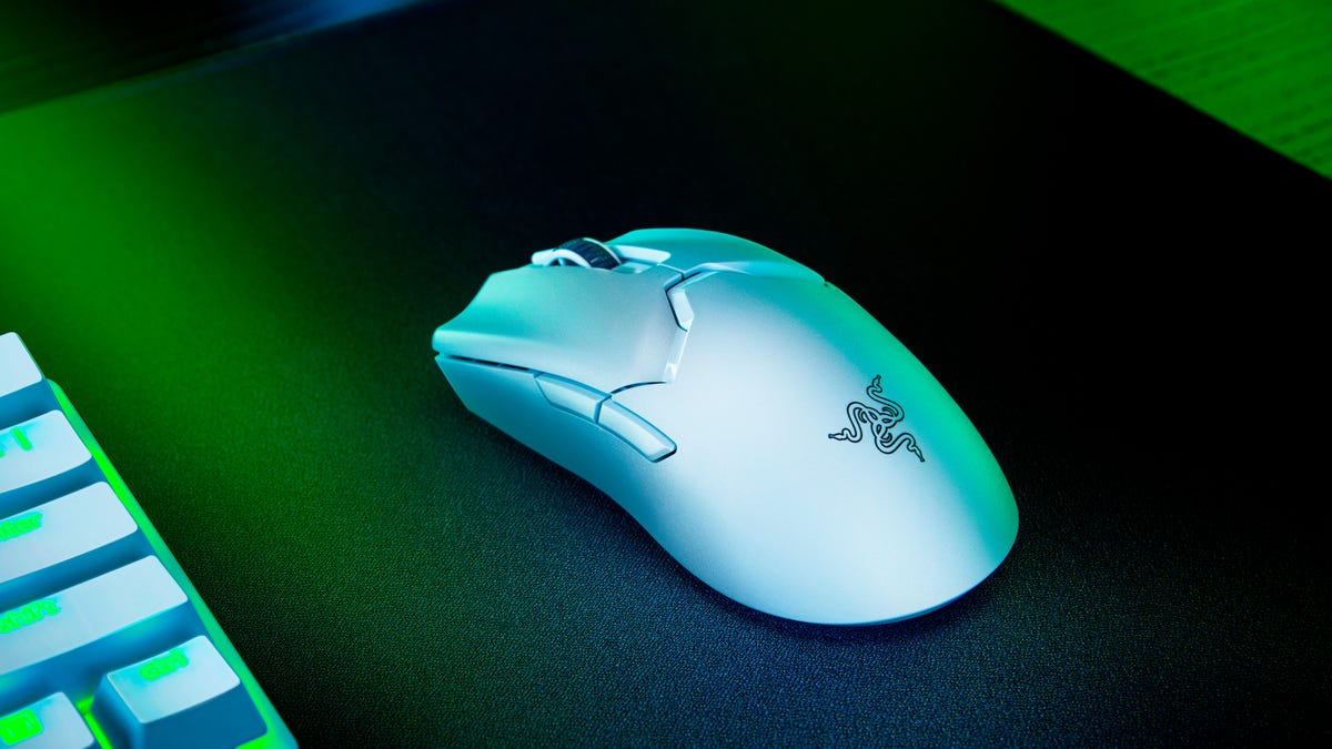Razer Viper V2 Pro wireless esports mouse in white in dark lighting next to a keyboard