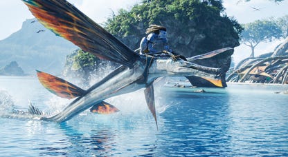 Jake Sully flies over Pandora's waters on a winged creature's back in Avatar: The Way of Water