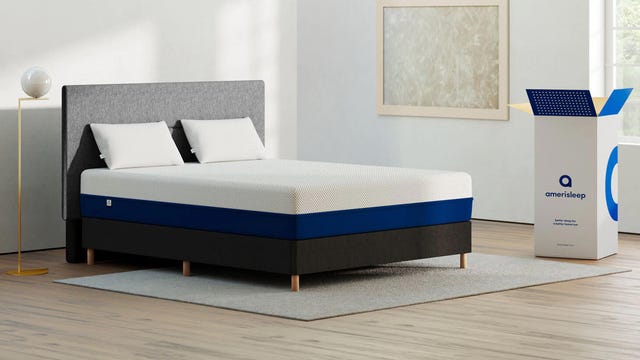 An Amerisleep AS2 Hybrid bed with a white rug underneath.