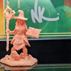 A witch D&D miniature in pink resin