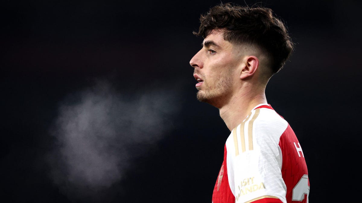 Side on picture of Arsenal forward breathing out steam.
