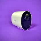 The Arlo Go 2 security camera against a purple background.