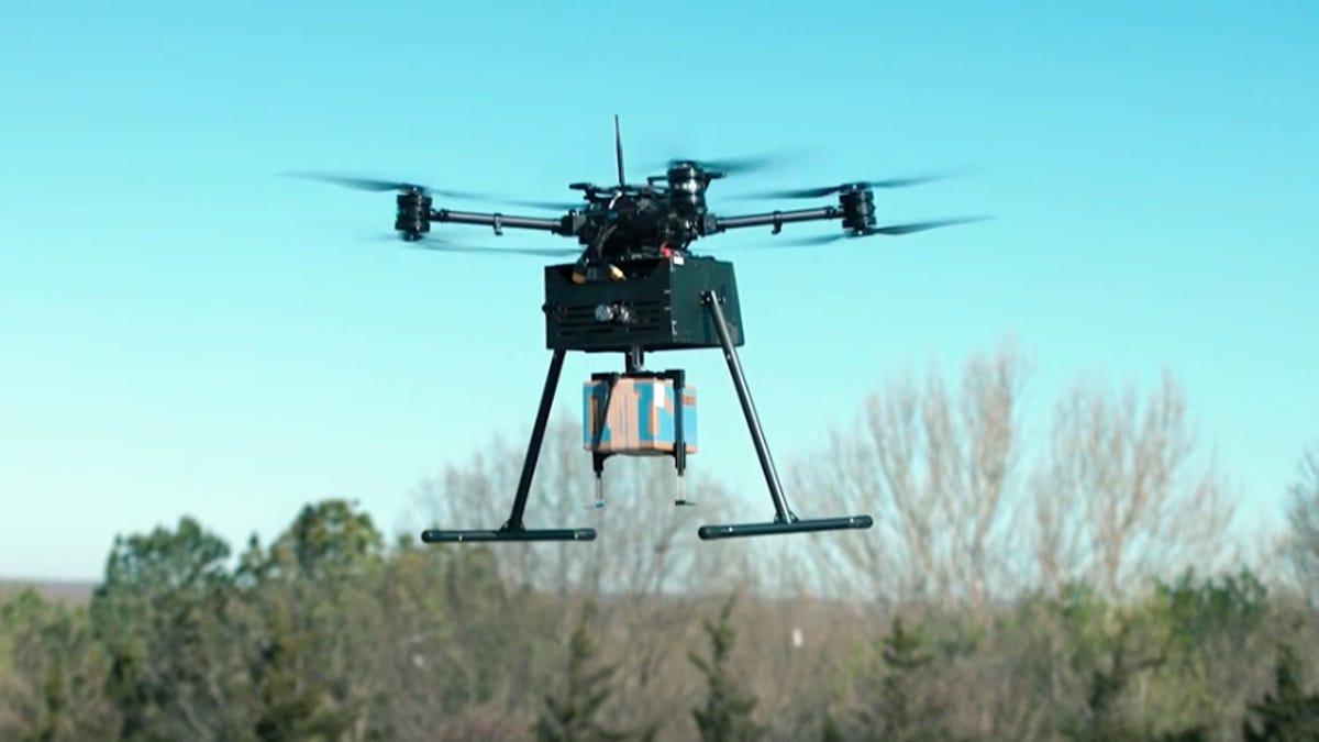 Drone flying while carrying a Walmart package.