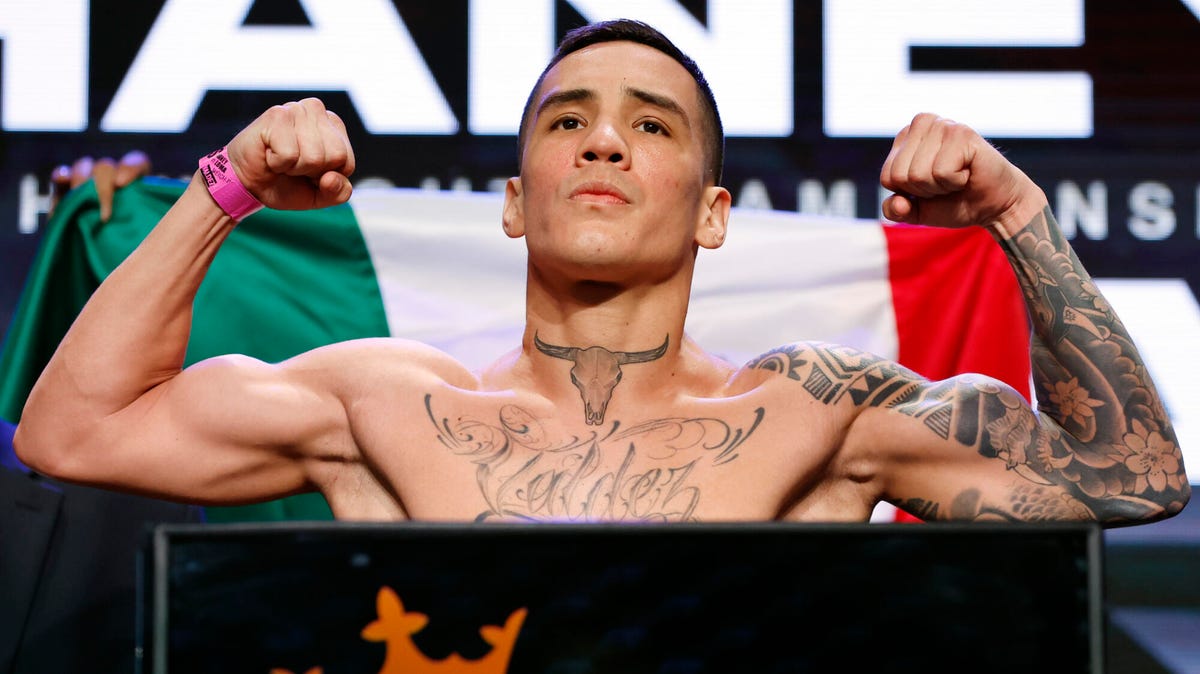 Over Oscar Valdez  at a weigh in - flexing both arms muscles.