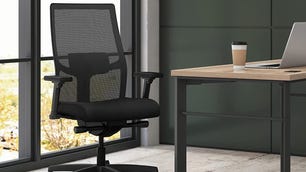 Office chair next to desk with coffee on.