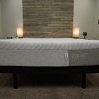 The Casper Wave Hybrid mattress on a bed frame. 