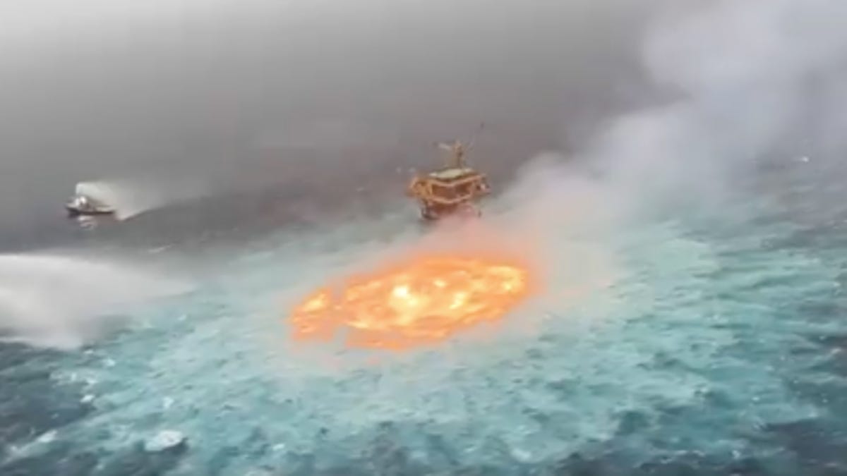 Boats work to extinguish fire in the Gulf of Mexico