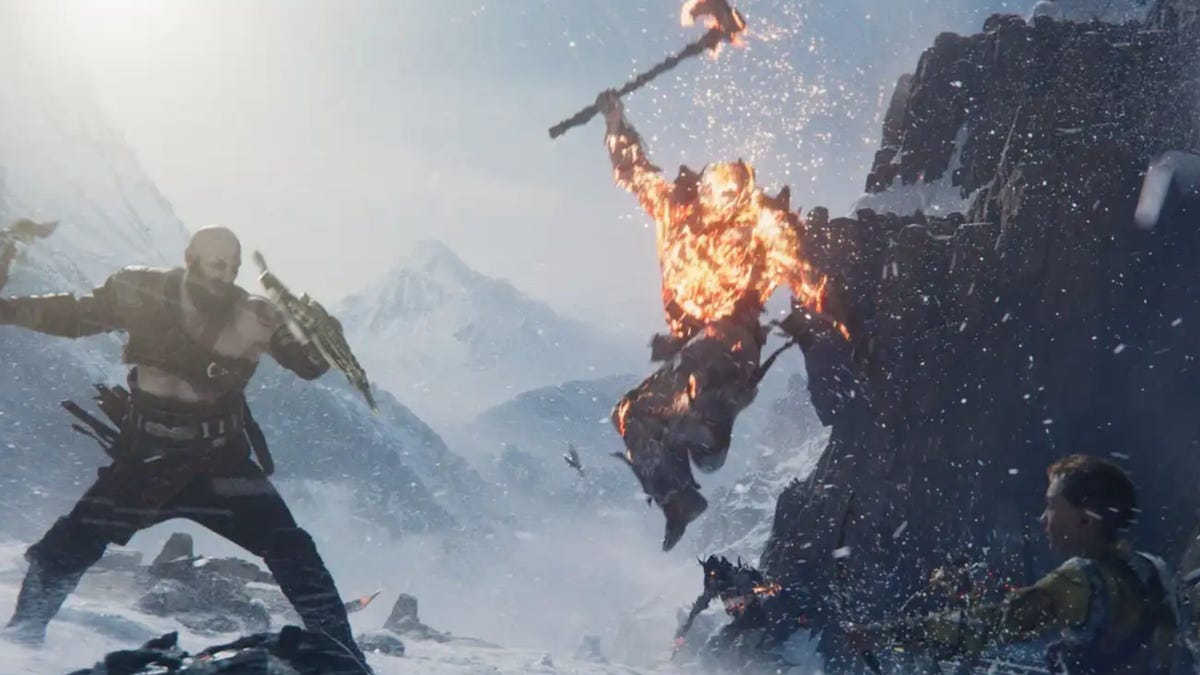 Kratos and Atreus battle a burning warrior in a God of War Ragnarok screenshot