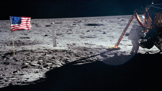 Neil Armstrong works on the surface of the moon near the lunar module