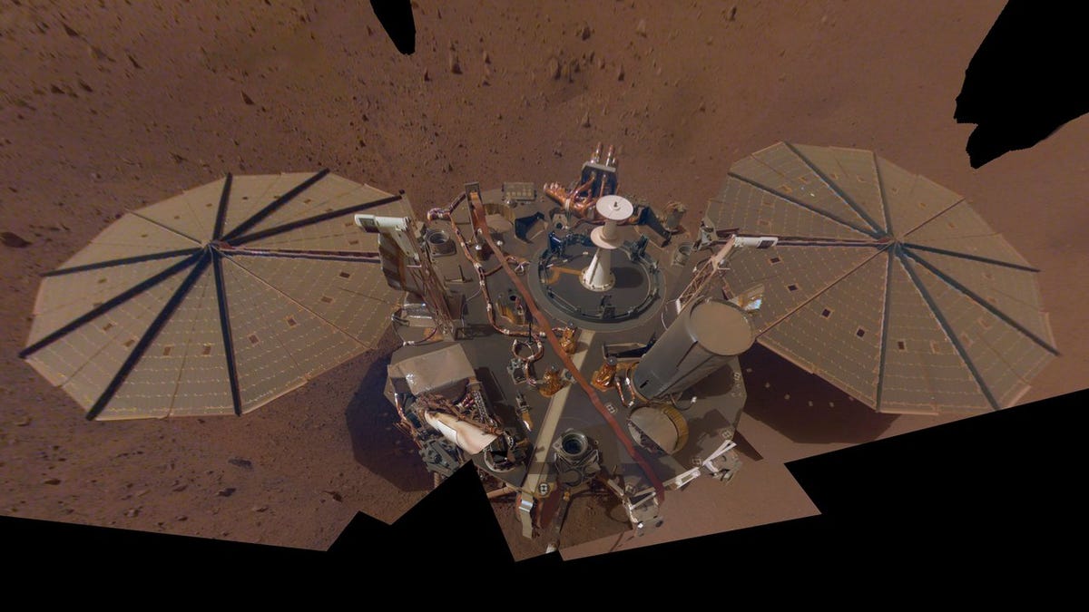 NASA's InSight lander on Mars with two umbrella-like solar panels on either side of its body.