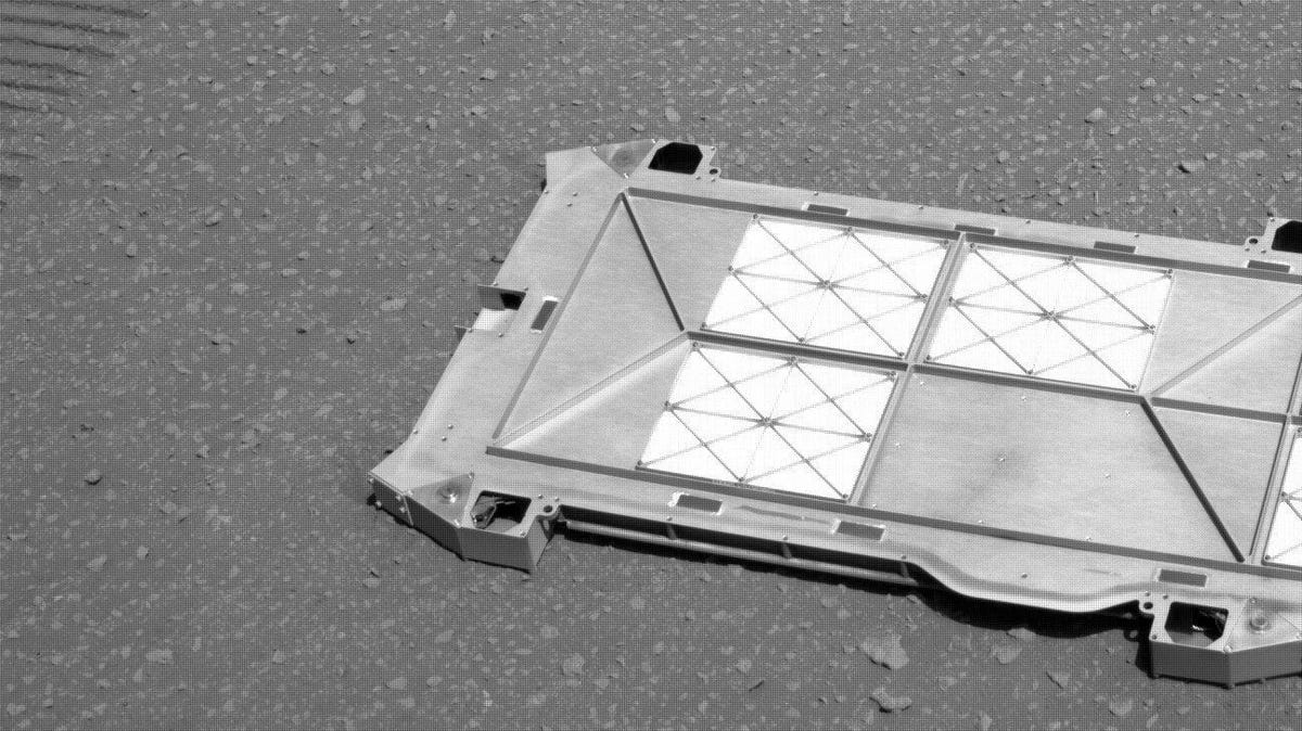 A pan-like piece of equipment lays on the Martian ground.