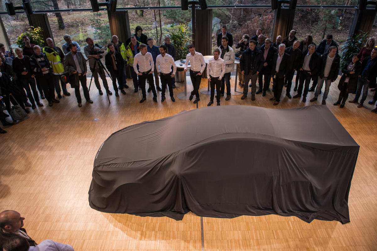 Polestar racecar under a sheet about to be revealed