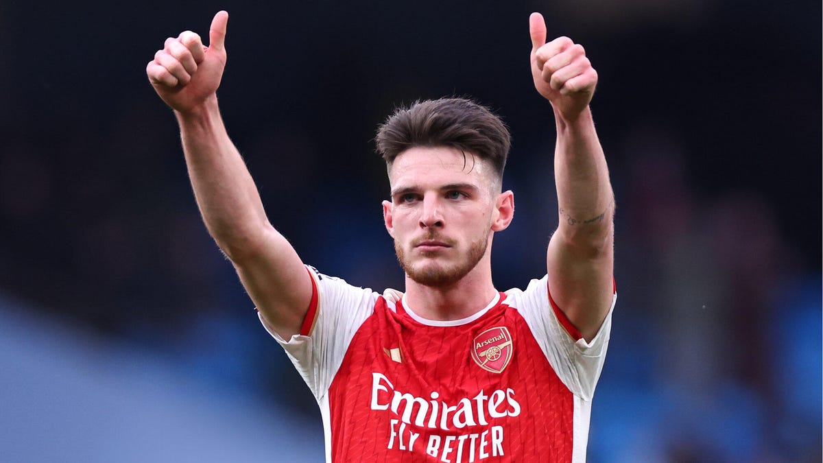 Declan Rice of Arsenal celebrating holding both hands aloft and making 'thumbs up' gesture.