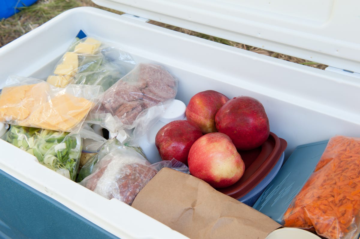 Food in a cooler including apples, cheese and meat