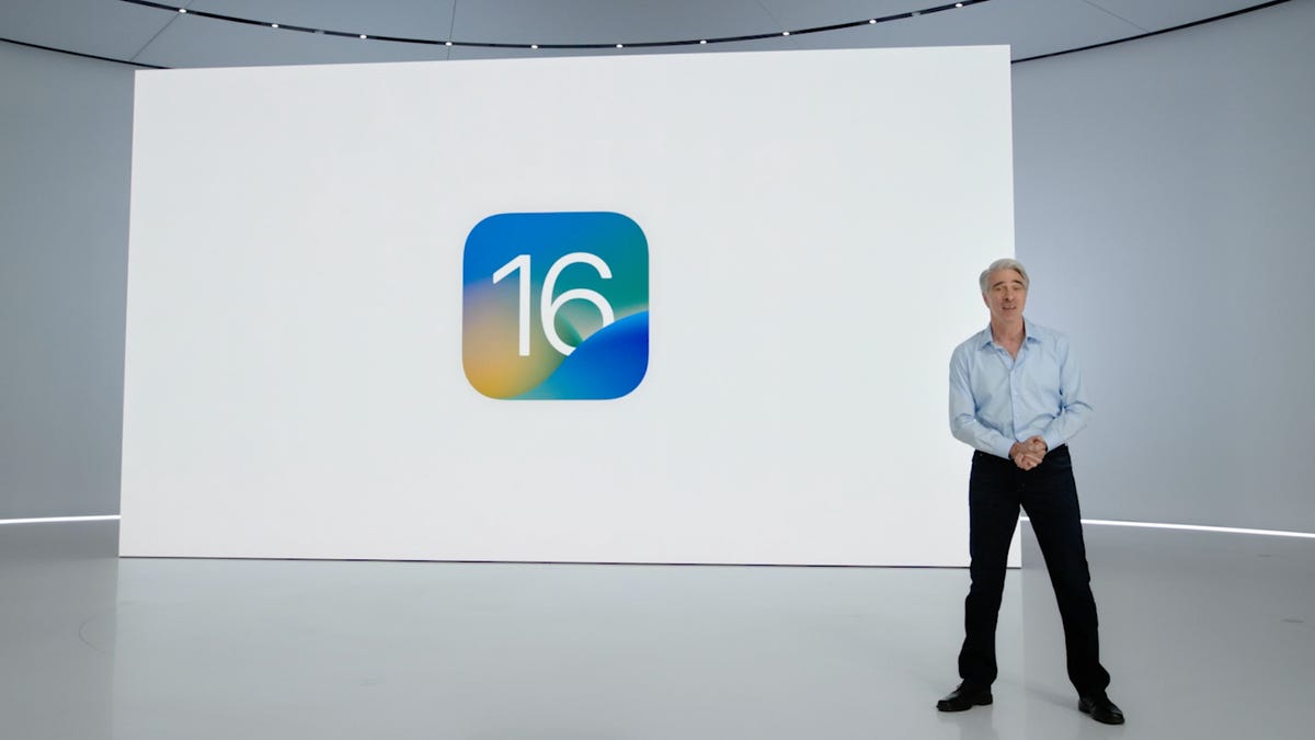 Apple SVP Craig Federighi presents at WWDC 2022 in front of an iOS 16 logo