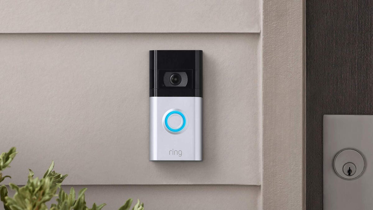 A white Ring video doorbell mounted on the exterior of a house.