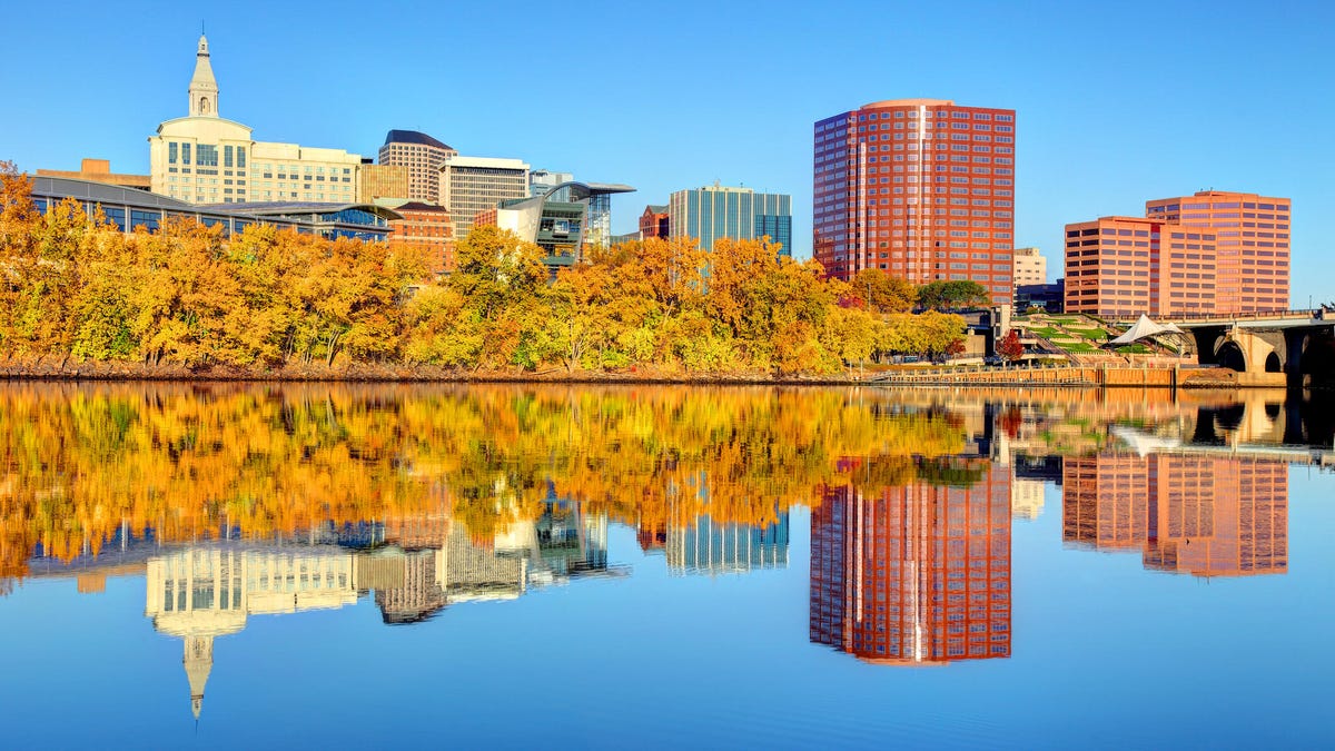 Sunlight on the Hartford, Connecticut, skyline and trees in autumn colors.