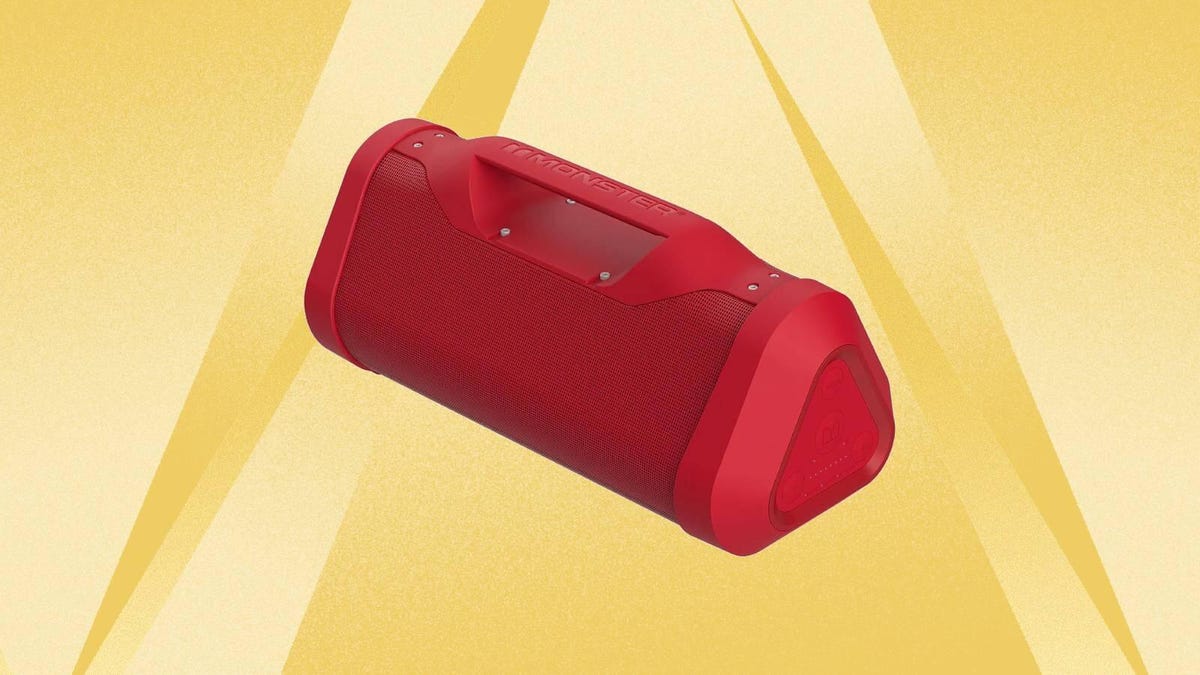 A red Monster Bluetooth boom box speaker against a yellow background.