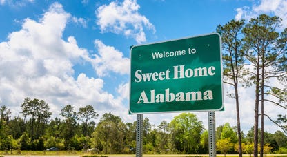 Welcome to Sweet Home Alabama road sign along Interstate 10 in Alabama, near the state border with Florida.