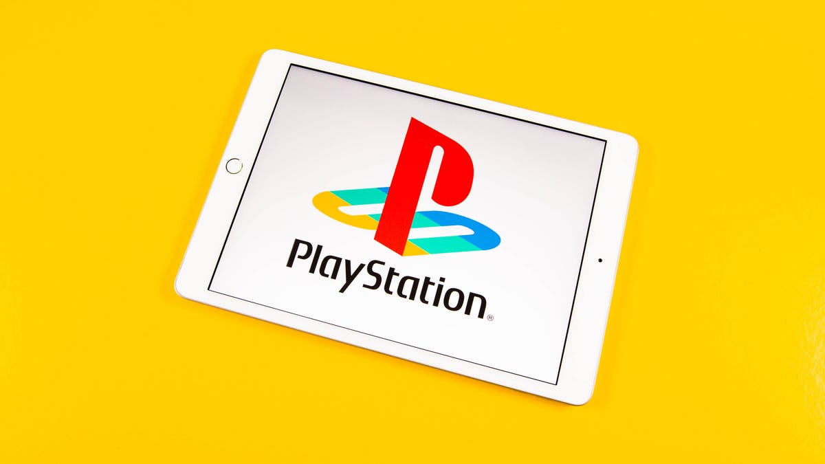 Playstation logo on a iPad against a yellow background