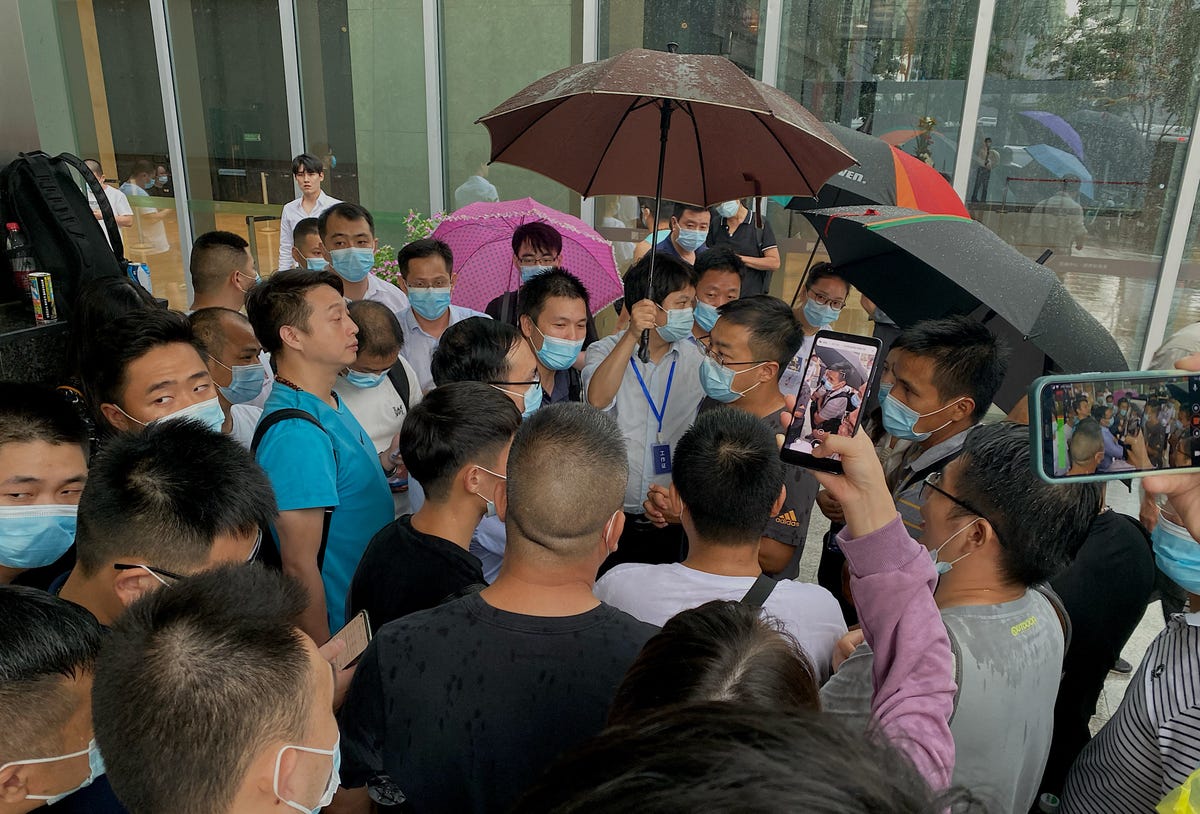 Throng of people outside an Evergrande office