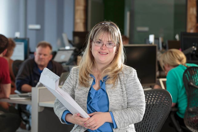 Kate Bartlett, who has Down syndrome, has been working as a benefits assistant at Aquent for 11 years, where she uses technology skills to do her job.
