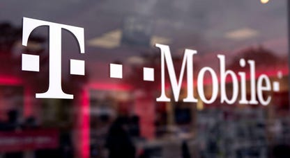 A T-Mobile logo is seen displayed on a store in Los Angeles