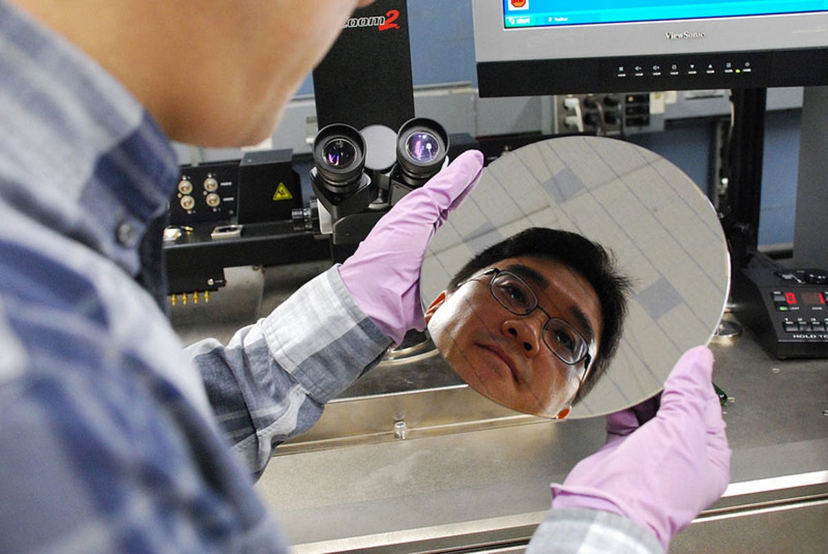 IBM researcher Hongsik Park looks over a chip wafer with carbon nanotubes. The wafer has two surfaces, trenches made of hafnium oxide that attract carbon nanotubes in a special solution silicon oxide that doesn't.