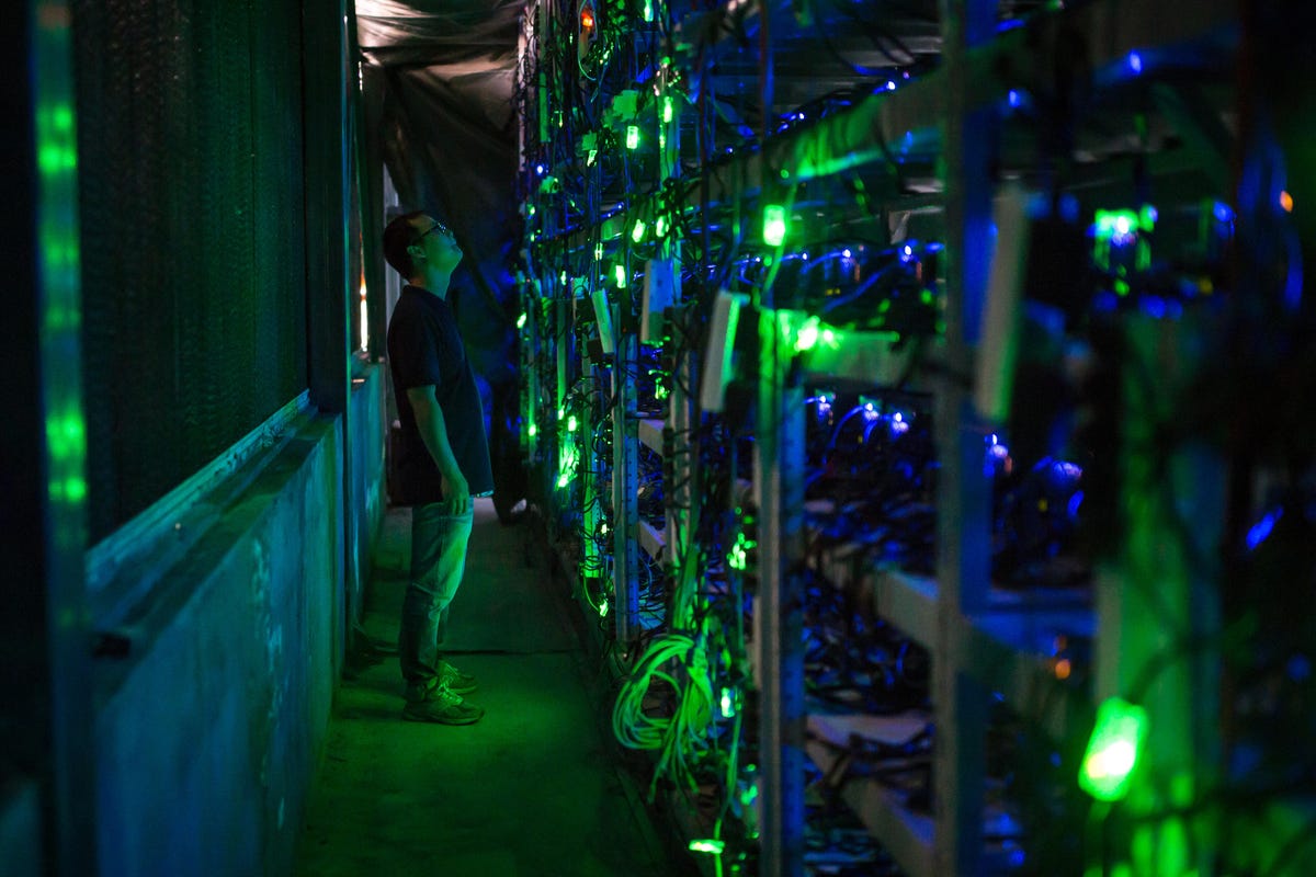 Racks of servers illuminated by blue and green lights