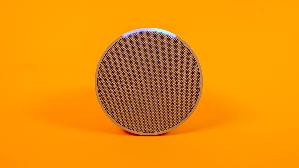 Amazon Pop smart speaker on an orange background