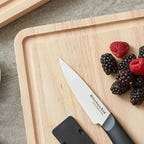 cutting board with berries and knife