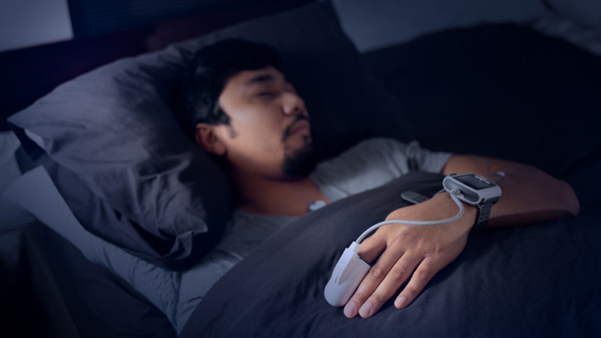 Man wearing an at-home sleep test while in bed. 