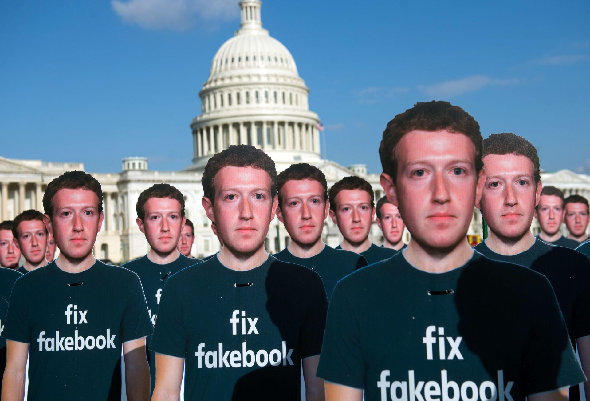 Cardboard cutouts of Mark Zuckerberg with the US Capitol building in the background.