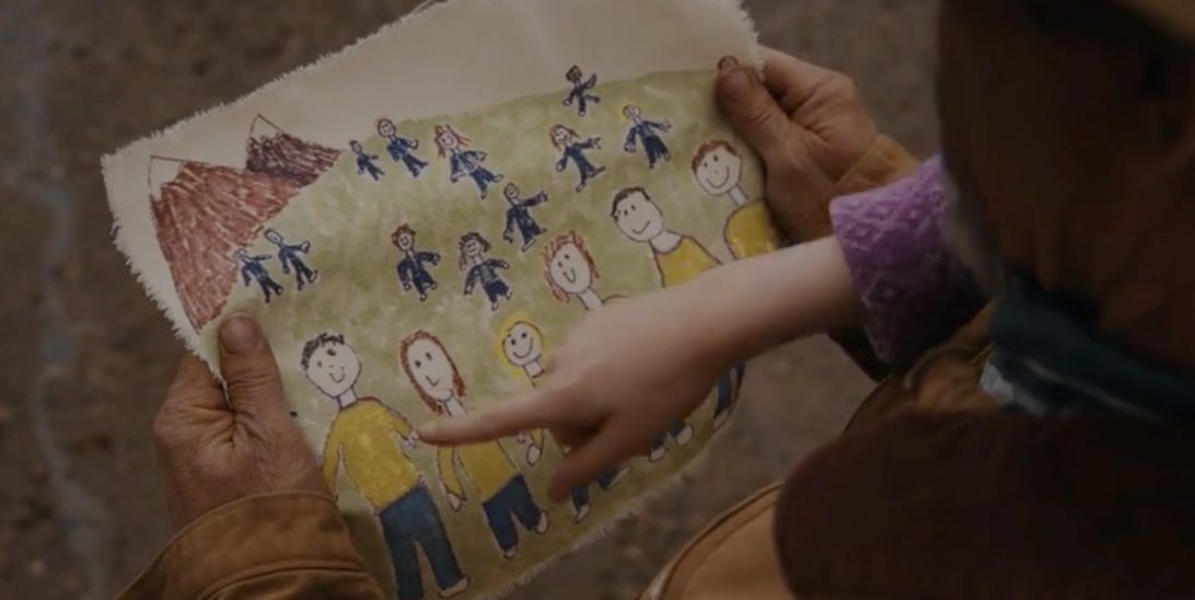Children's drawing of over a dozen people in blue and yellow clothes.