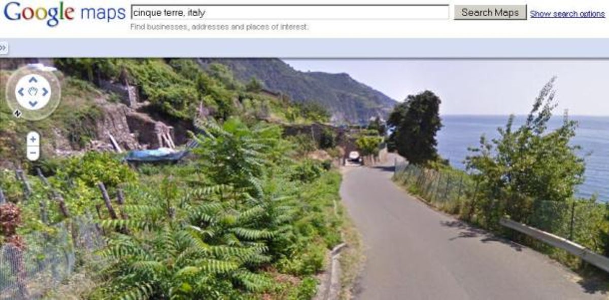 A Google Street View image of a coastal road in the Cinque Terre region of northern Italy.