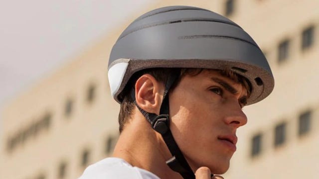 wearing foldable gray bike helmet