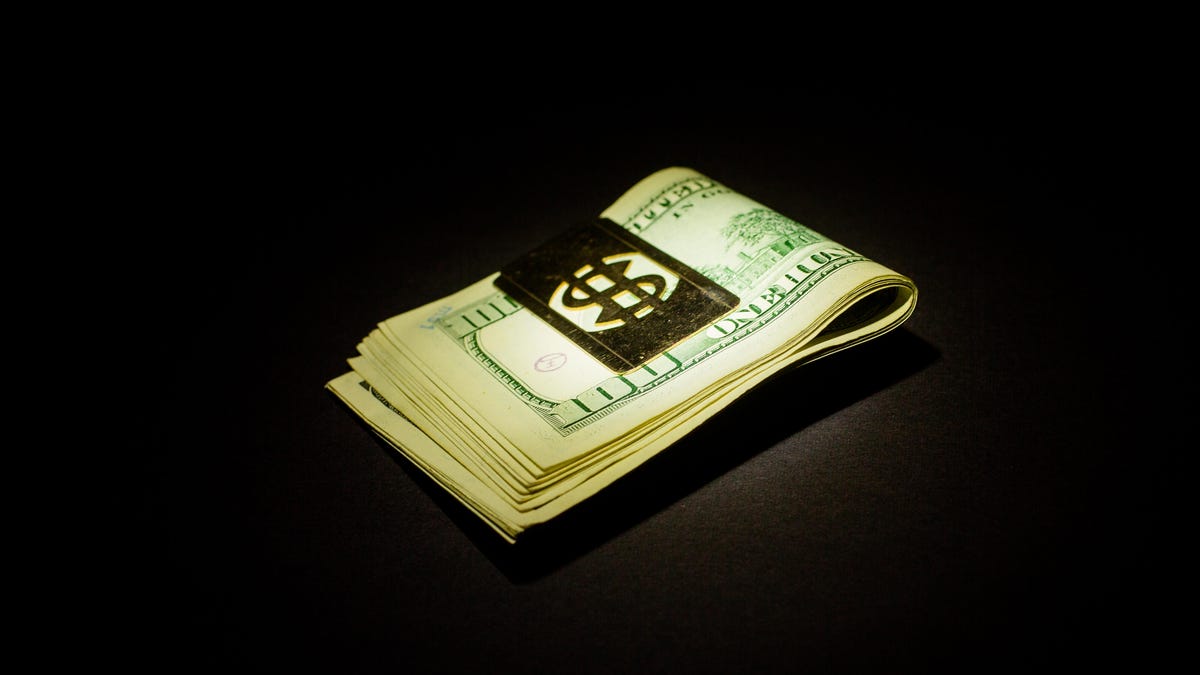 002-money-cash-dollar-bills-hundreds-spotlight-black-background-money-clip-stimulus-check-bill-savings-poverty-hope