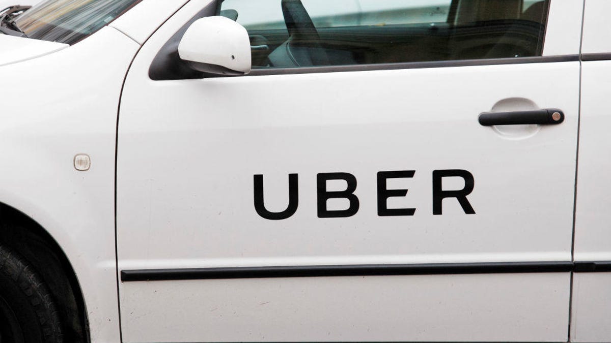 Uber logo is seen on a car's door on the street in Kiev,